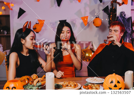 Joyful office Halloween party with coworkers in costumes, celebrating with drinks and laughter, fostering teamwork and festive spirit 132563507