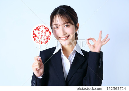 Image of a female office worker holding a very well done plate Image of a female office worker holding a very well done plate 132563724