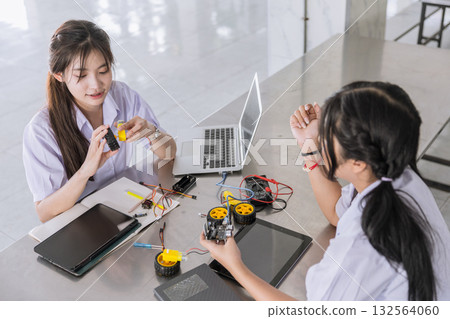 Students teen in uniform learning STEM with iot electricity circuit board component at school campus 132564060