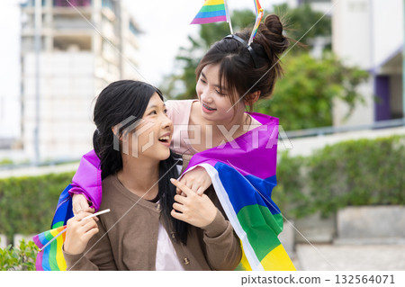Women teen with colorful LGBTQ pride month rainbow flag, couple female happy smiling enjoy together 132564071