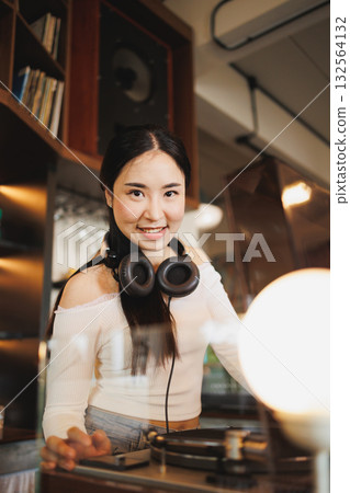 DJ Asian women young teen with music player, party sound entertainment happy smiling expression DJ Asian women young teen with music player, party sound entertainment happy smiling expression 132564132