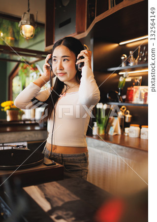 DJ Asian women young teen with music player, party sound entertainment happy smiling expression DJ Asian women young teen with music player, party sound entertainment happy smiling expression 132564149