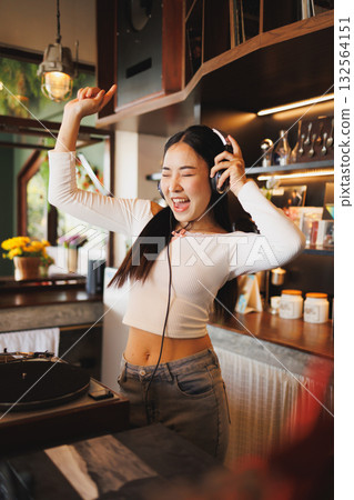 DJ Asian women young teen with music player, party sound entertainment happy smiling expression DJ Asian women young teen with music player, party sound entertainment happy smiling expression 132564151