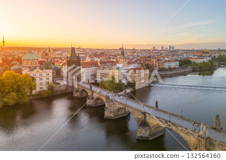 Morning sunlight gently illuminates Prague Castle in the background, while people stroll across Charles Bridge over the Vltava River, creating a serene early day scene in Prague. Morning sunlight gently illuminates Prague Castle in the background, while people stroll across Charles Bridge over the Vltava River, creating a serene early day scene in Prague. 132564160