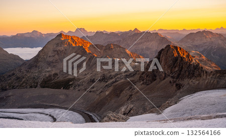 Early sunlight illuminates the rugged peaks surrounding Pers Glacier in the Bernina Range. The serene alpine landscape showcases the beauty of Swiss nature at dawn. Early sunlight illuminates the rugged peaks surrounding Pers Glacier in the Bernina Range. The serene alpine landscape showcases the beauty of Swiss nature at dawn. 132564166