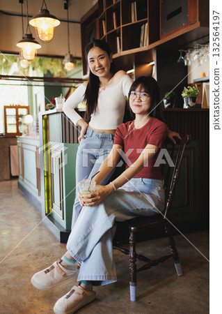portrait of two beauty Asian women teen sitting together indoor friend happy smiling portrait of two beauty Asian women teen sitting together indoor friend happy smiling 132564197
