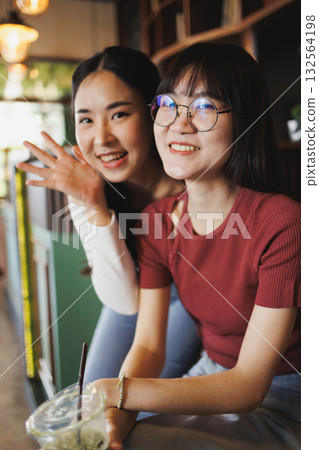 portrait of two beauty Asian women teen sitting together indoor friend happy smiling portrait of two beauty Asian women teen sitting together indoor friend happy smiling 132564198
