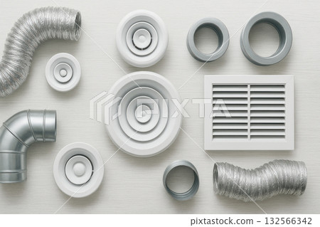HVAC ventilation parts and flexible duct hoses arranged for an air flow system. clean engineering composition of components for climate control on white wooden background HVAC ventilation parts and flexible duct hoses arranged for an air flow system. clean engineering composition of components for climate control on white wooden background 132566342
