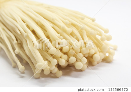 Enoki Mushrooms. Close-up of fresh enoki mushrooms against a white background. Enoki Mushrooms. Close-up of fresh enoki mushrooms against a white background. 132566570