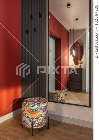 Stylish Hallway Interior with Red Walls and Modern Design 132567220