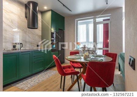 Modern Kitchen Interior with Green Cabinets and Red Chairs Modern Kitchen Interior with Green Cabinets and Red Chairs 132567221