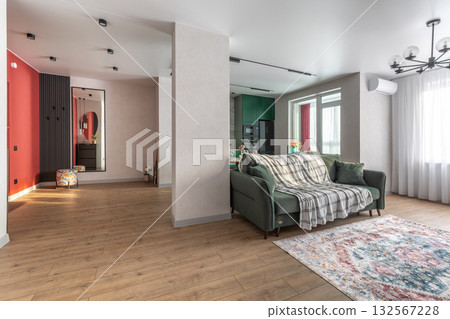 Spacious Modern Living Room with Green Sofa and Open Layout 132567228