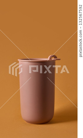 Clay reusable mug on warm background representing sustainable beverage mockup 132567592