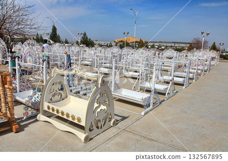 Turkmenistan. Ashkhabad market. Handmade cradles for babies. 132567895