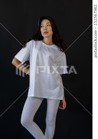 Ecommerceready photograph featuring confident model wearing basic activewear in studio setting Ecommerceready photograph featuring confident model wearing basic activewear in studio setting 132567962