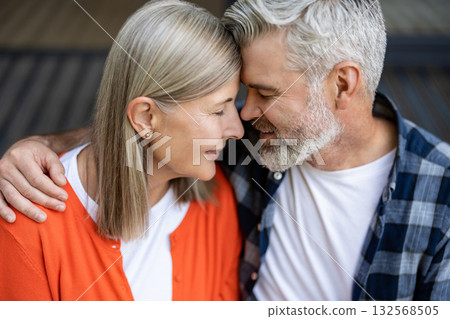 Man and woman sitting together hugging and feeling in love Man and woman sitting together hugging and feeling in love 132568505