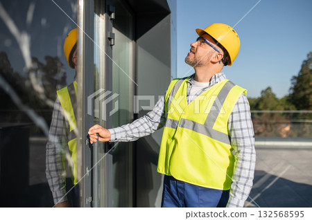 Engineer inspecting modern building facade 132568595