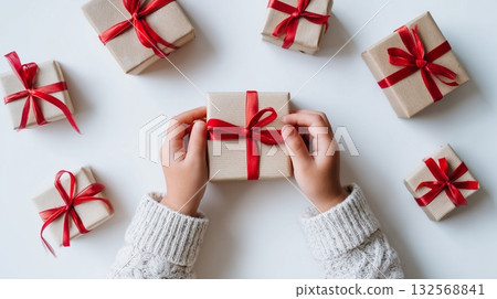 Gift-giving moment with neatly wrapped presents on white background during festive season 132568841