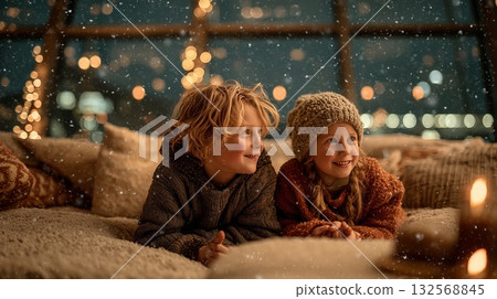 Children enjoy a cozy winter evening indoors with festive lights and snowfall 132568845