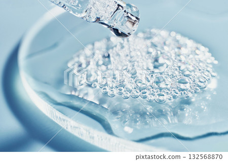 Close-up of clear Cosmetic liquid and bubbles on glass surface in laboratory setting Close-up of clear Cosmetic liquid and bubbles on glass surface in laboratory setting 132568870