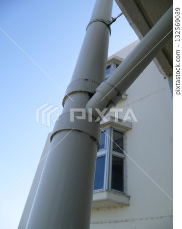 Drainage pipes visible from the emergency stairs of an apartment building 132569089