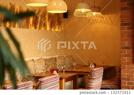 A Cozy Restaurant Interior Featuring Elegant Lighting Designs and Comfortable Seating Arrangements A Cozy Restaurant Interior Featuring Elegant Lighting Designs and Comfortable Seating Arrangements 132571911