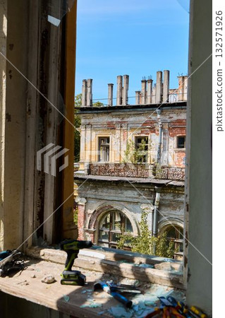 View from an Abandoned Building Window Featuring Overgrown Architecture and Urban Decay View from an Abandoned Building Window Featuring Overgrown Architecture and Urban Decay 132571926