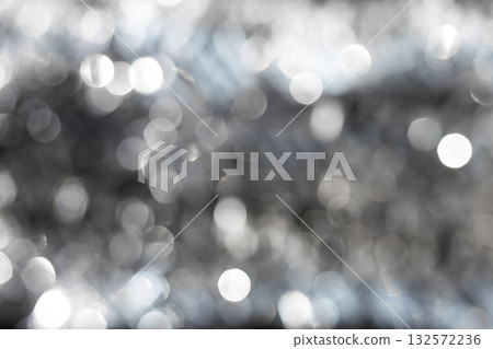 Silver and white bokeh background with soft blurred circles of light creating sparkling festive texture. Elegant abstract ideal for luxury design, winter holiday themes, modern minimalist compositions 132572236