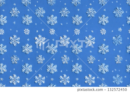 Winter design. Seamless pattern in a drawing style. Blue snowflakes equidistant from each other. Minimalist style. 132572450