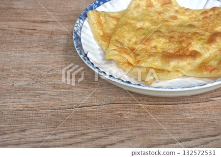 fried roti southern flat bread on white paper tray in plate fried roti southern flat bread on white paper tray in plate 132572531