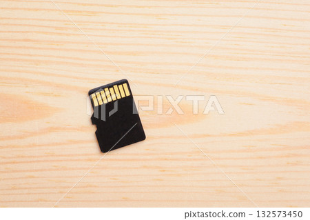 Micro sd memory card on light wooden background Micro sd memory card on light wooden background 132573450