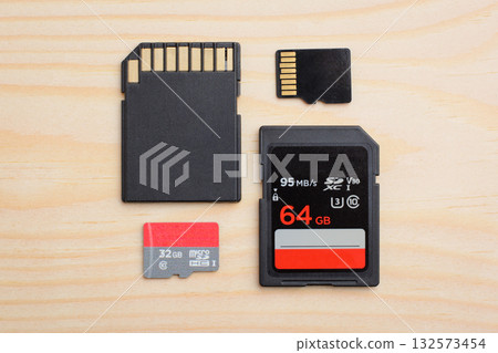 Fast Sd and micro sd cards on light wooden table Fast Sd and micro sd cards on light wooden table 132573454
