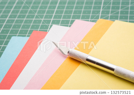 Scalpel on a stack of colorful papers Scalpel on a stack of colorful papers 132573521