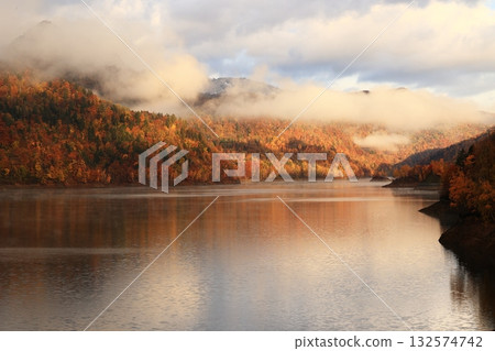 A lake where autumn leaves have begun to change color A lake where autumn leaves have begun to change color 132574742