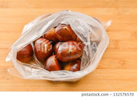 Raw chestnuts in a bag 132576570