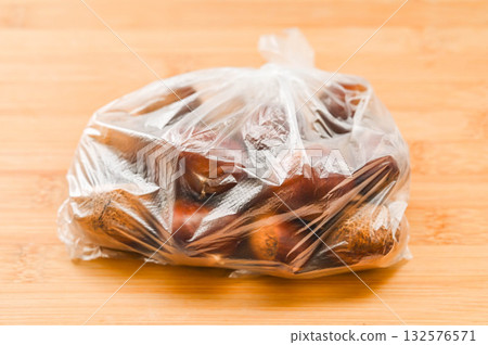 Raw chestnuts in a bag Raw chestnuts in a bag 132576571
