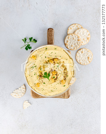 Lupin hummus or turmeric hummus with olive oil and herbs on a white background. Healthy vegan concept. Lupin hummus or turmeric hummus with olive oil and herbs on a white background. Healthy vegan concept. 132577773