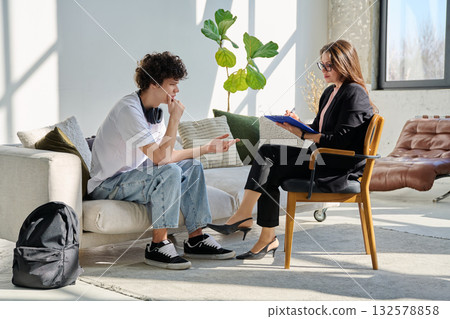 Young man in mental session talking with professional psychologist Young man in mental session talking with professional psychologist 132578858