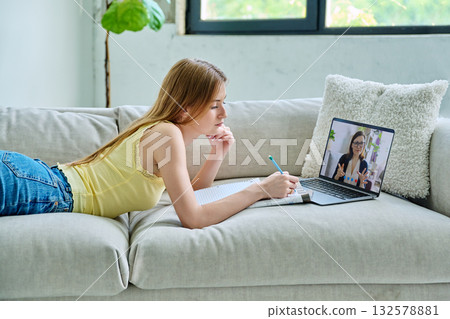 Teenage girl student having online lesson, watching webinar, at home 132578881