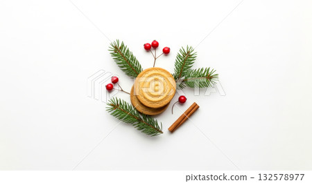Christmas gingerbread cookies and spices with fir branches and berries on white table. Christmas gingerbread cookies and spices with fir branches and berries on white table. 132578977