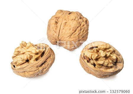 Whole walnut and cracked in shell walnut isolated on a white background Whole walnut and cracked in shell walnut isolated on a white background 132579060
