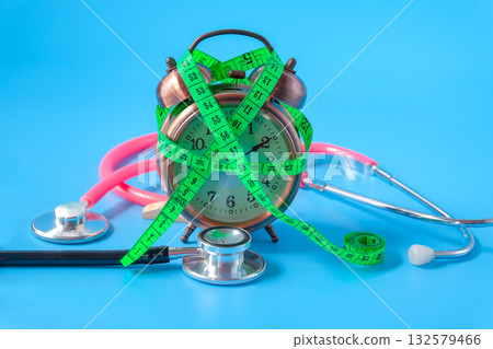 A Measuring tape for tying alarm clock lifestyle concept. 132579466