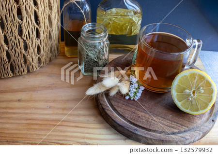 Wild flowers bouquet alongside herbal tea and alternative medicine for health and relaxation. 132579932