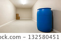 Large blue plastic barrel in an empty storage room with cardboard boxes. Large blue plastic barrel in an empty storage room with cardboard boxes. 132580451