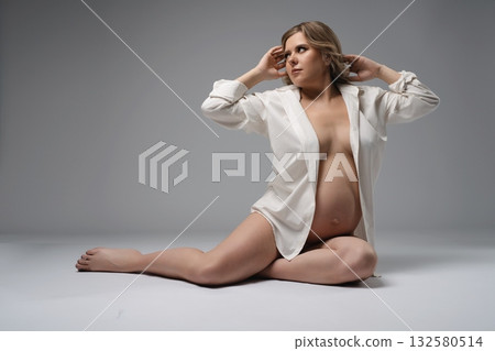 Pregnant Woman in White Shirt Posing Pregnant Woman in White Shirt Posing 132580514