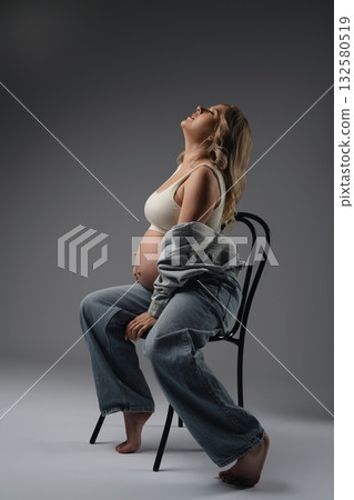 Pregnant Woman Sitting on Chair Pregnant Woman Sitting on Chair 132580519