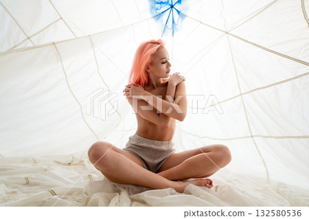 Woman With Pink Hair Sitting in a White Tent Woman With Pink Hair Sitting in a White Tent 132580536