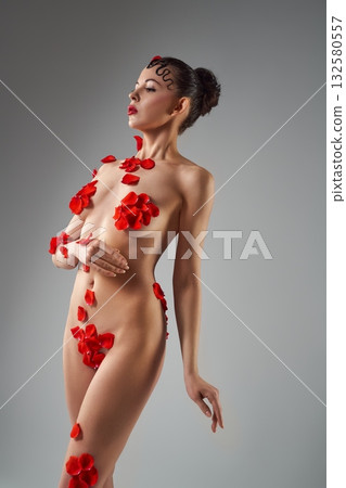Sensual naked woman covered with roses all over her body 132580557