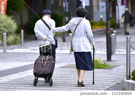 Yokohama cityscape in Japan: Aging society: Elderly man and woman with walking sticks (both wearing masks)... = October 28, Yokohama city 132580800