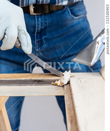 Carpenter at work, restoring an old wooden window. Carpentry. 132580903